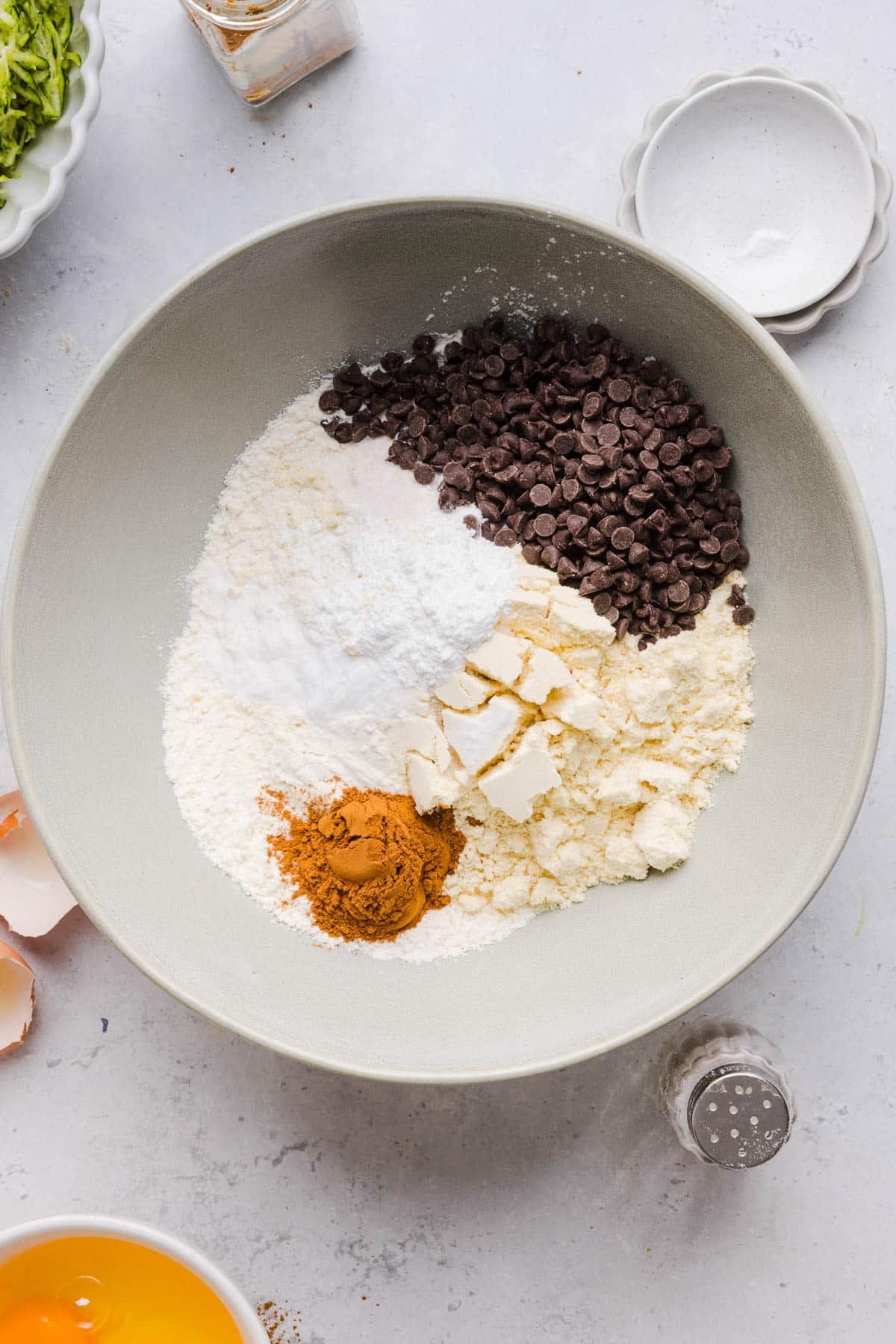 All of the dry ingredients for protein zucchini bread in a bowl on a countertop.