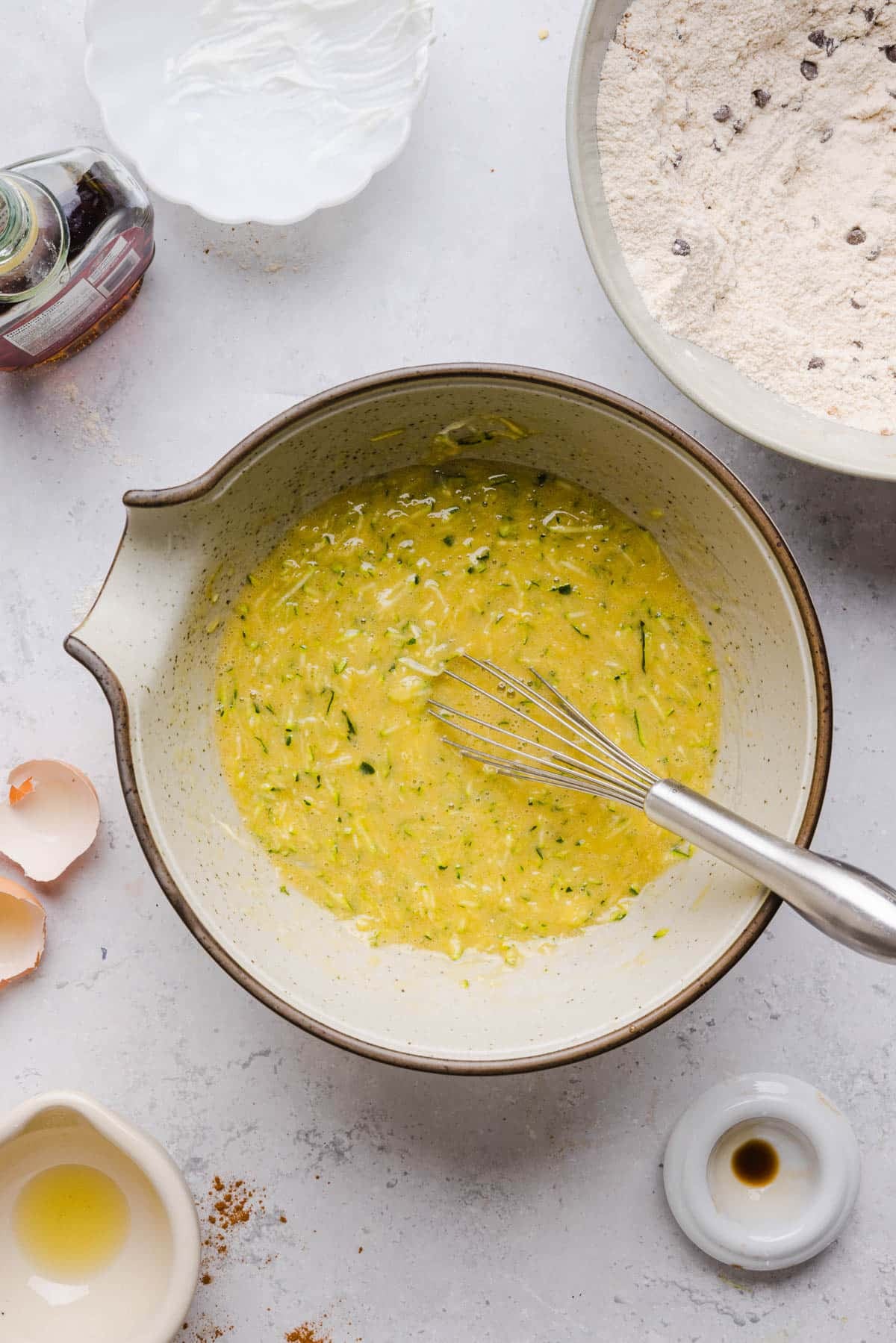 The wet ingredients whisked together in a bowl on a countertop.
