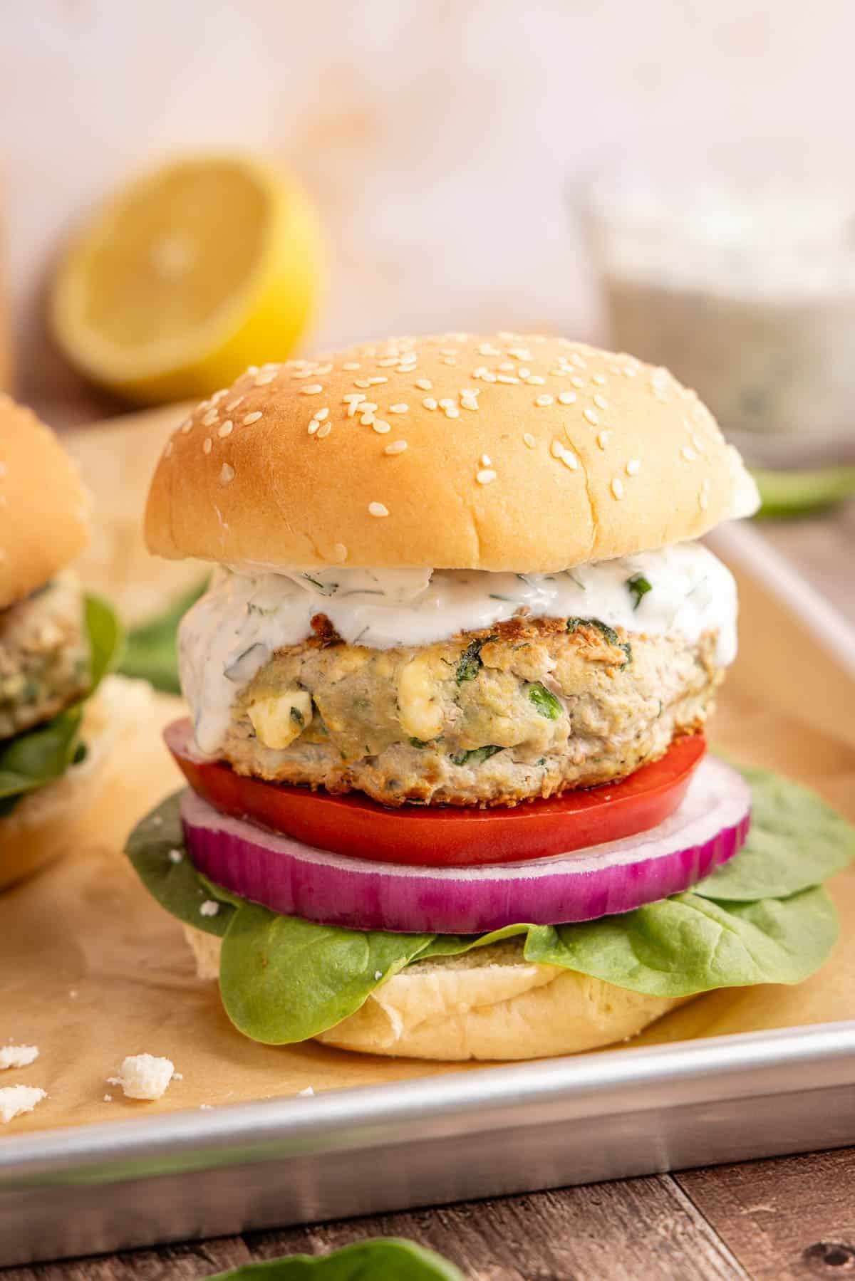 A spinach feta turkey burger on a baking sheet for serving.