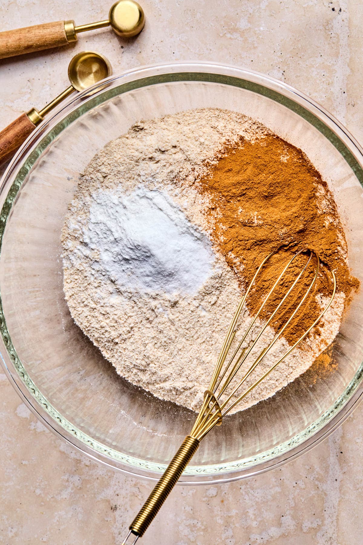 All of the dry ingredients in a large glass bowl before whisking together.