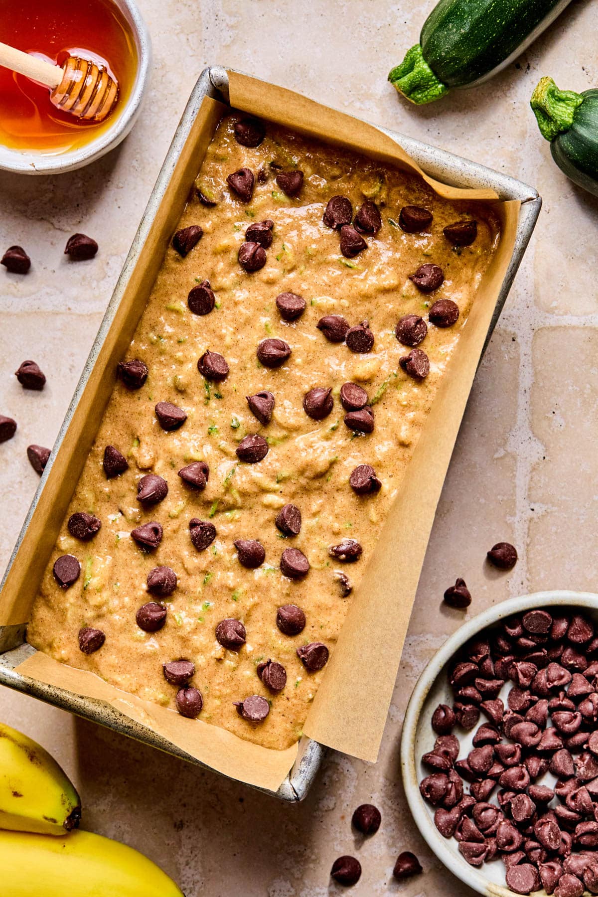 The batter in the loaf ban with chocolate chips sprinkled on top.