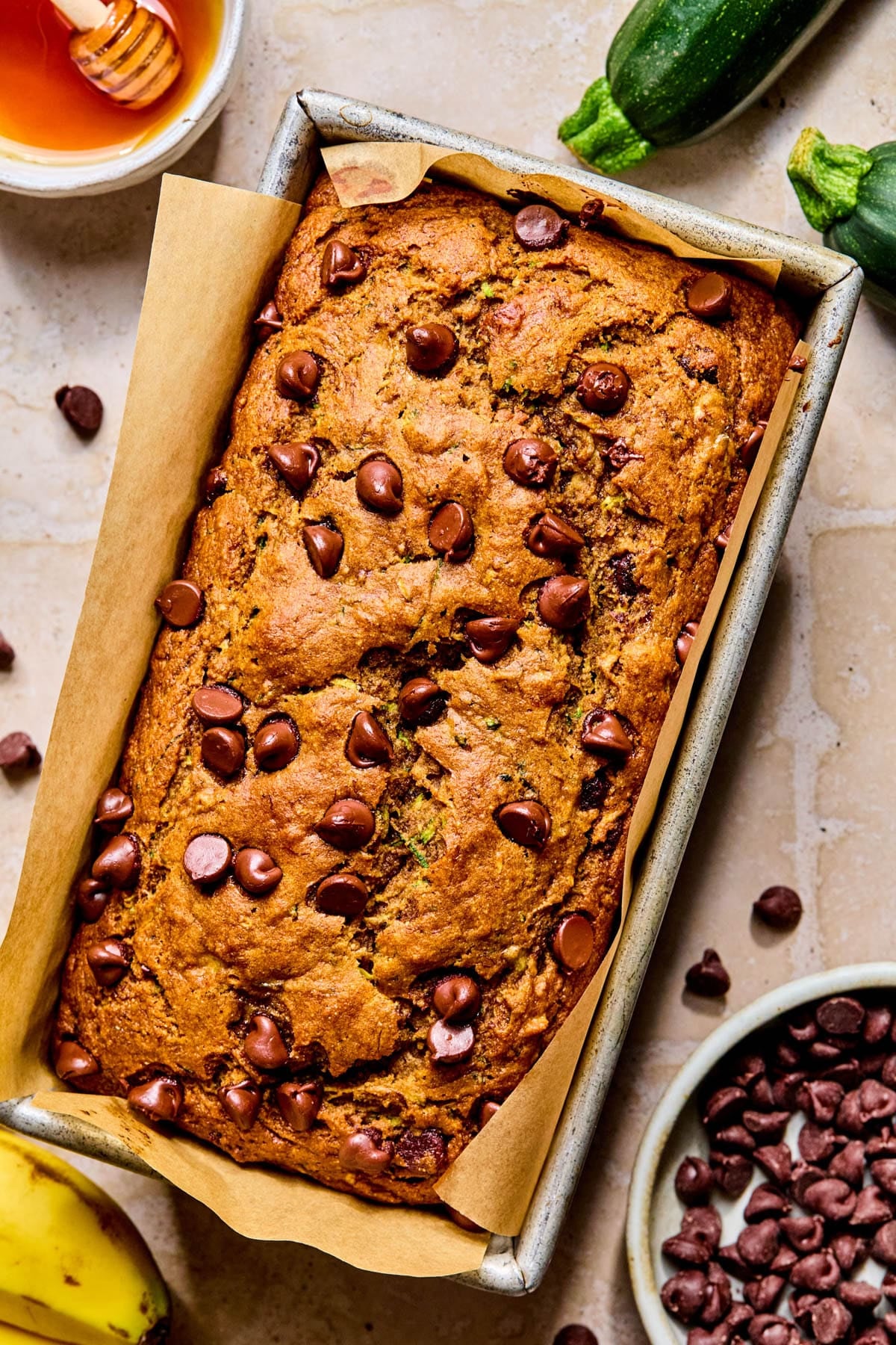 The baked chocolate chip zucchini banana bread in a loaf pan after baking.