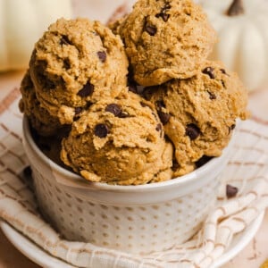 Edible pumpkin cookie dough scoops in a small bowl.