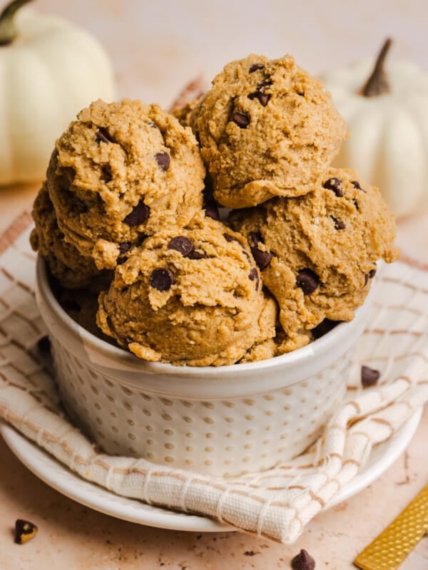 Edible pumpkin cookie dough scoops in a small bowl.