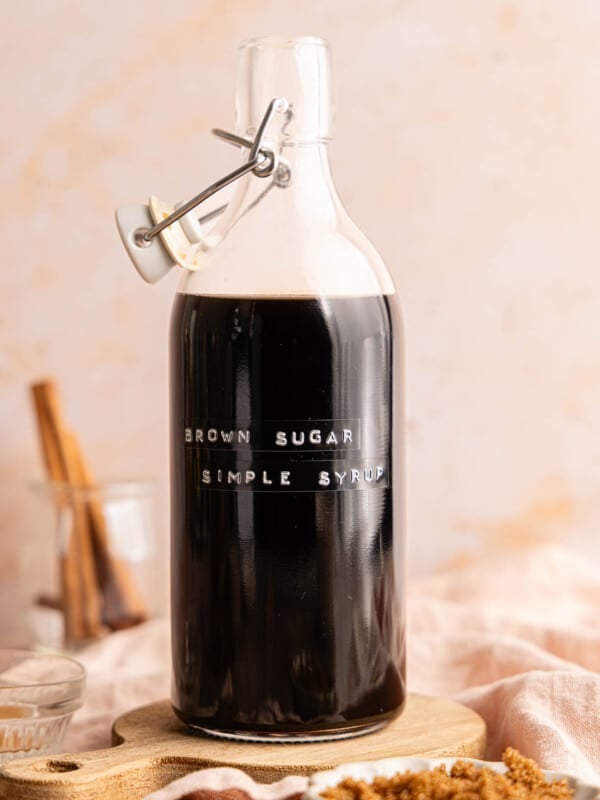 A bottle filled with brown sugar simple syrup on a countertop.