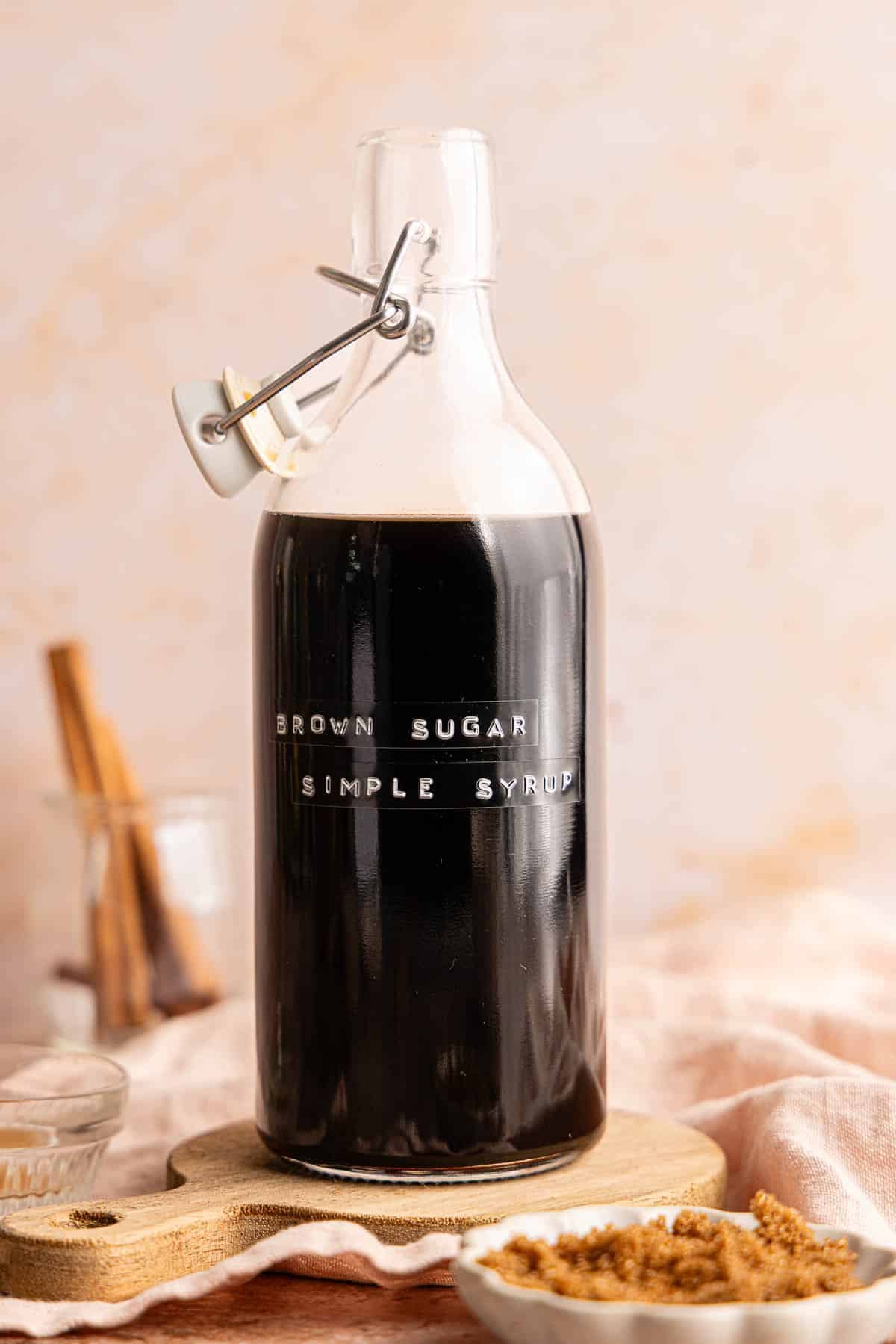 A bottle filled with brown sugar simple syrup on a countertop.