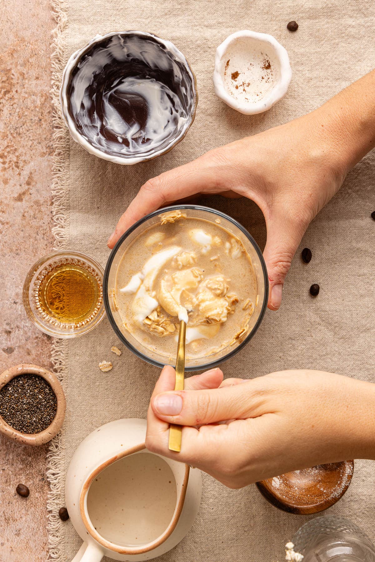 A spoon mixies all of the remaining ingredients in the glass jar.
