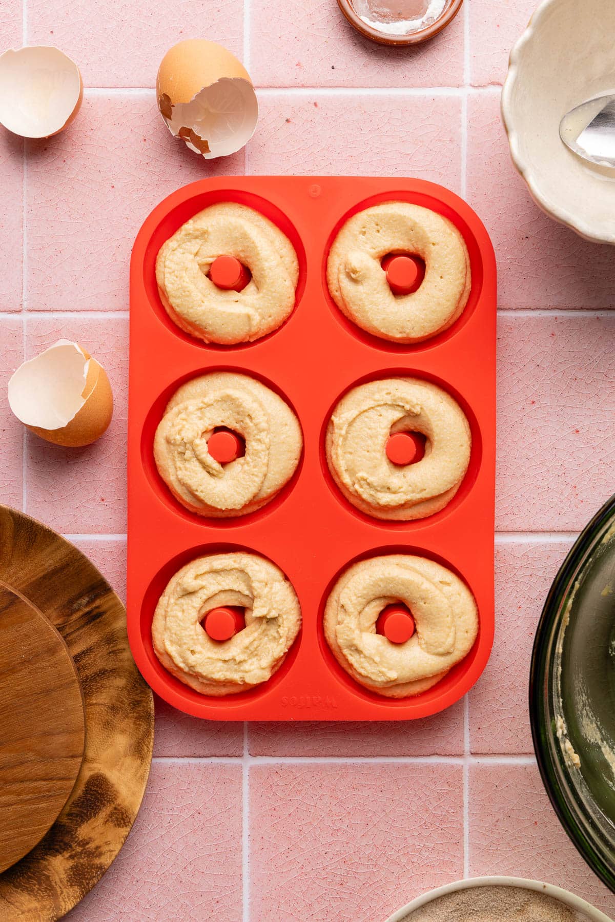 The donut batter in the donut pan before baking.