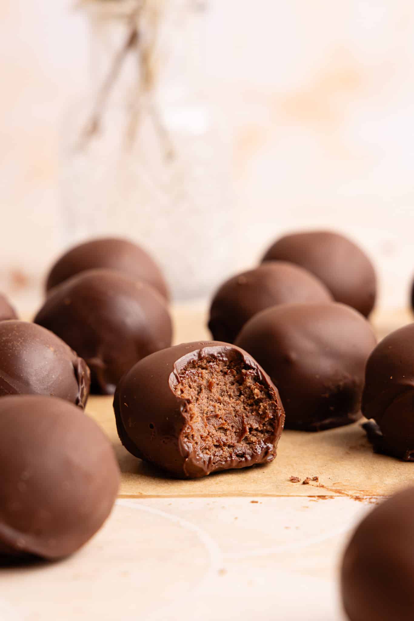 Cottage cheese truffles on a countertop with a bite taken out of one of them.