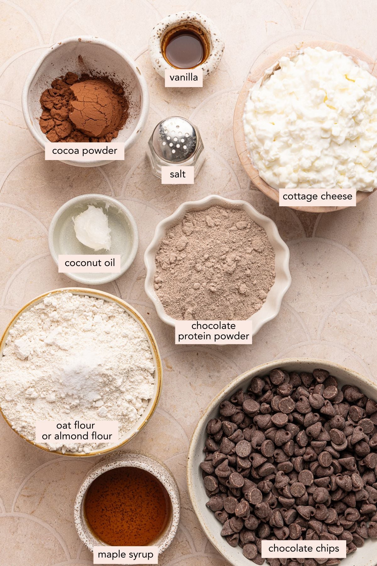 All of the ingredients for cottage cheese truffles in bowls on a countertop.