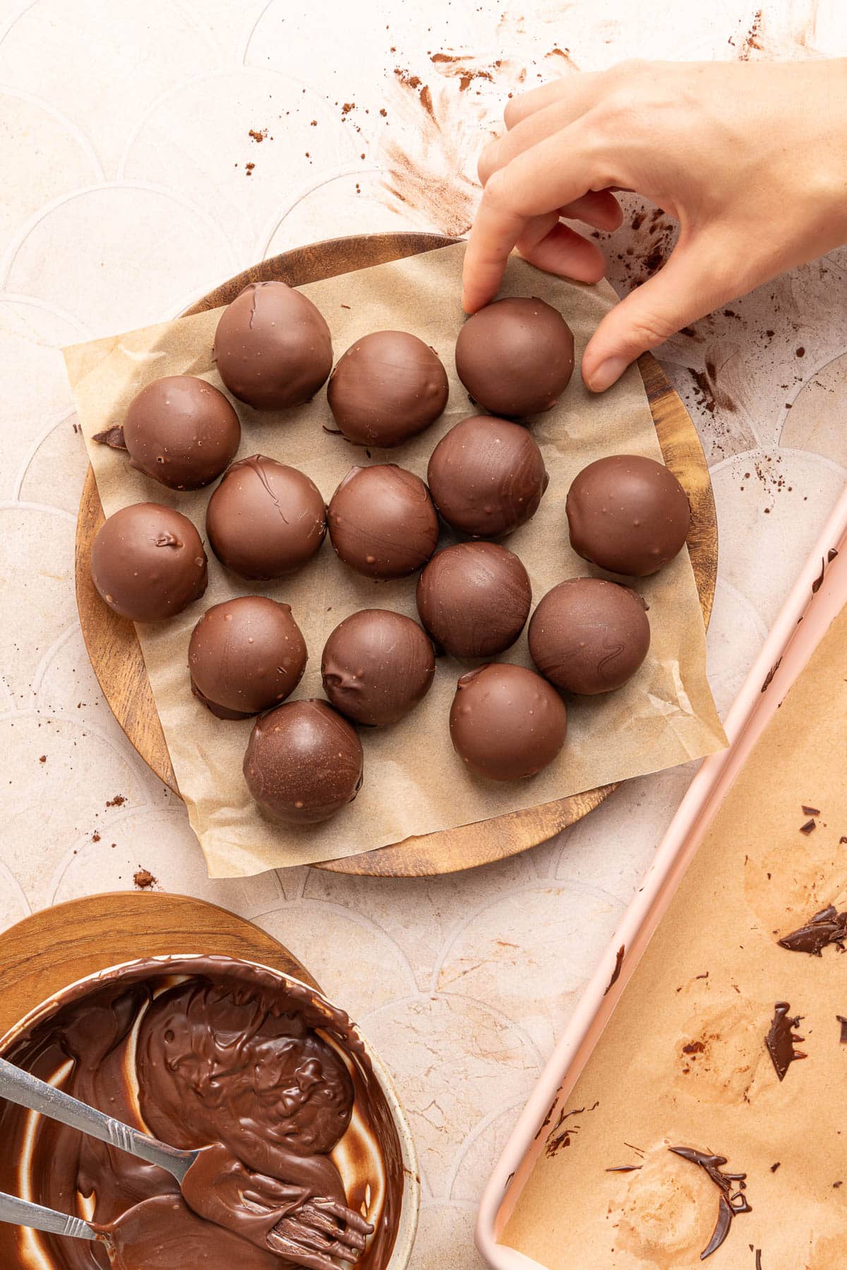 Cottage cheese truffles on parchment paper on top of a plate.