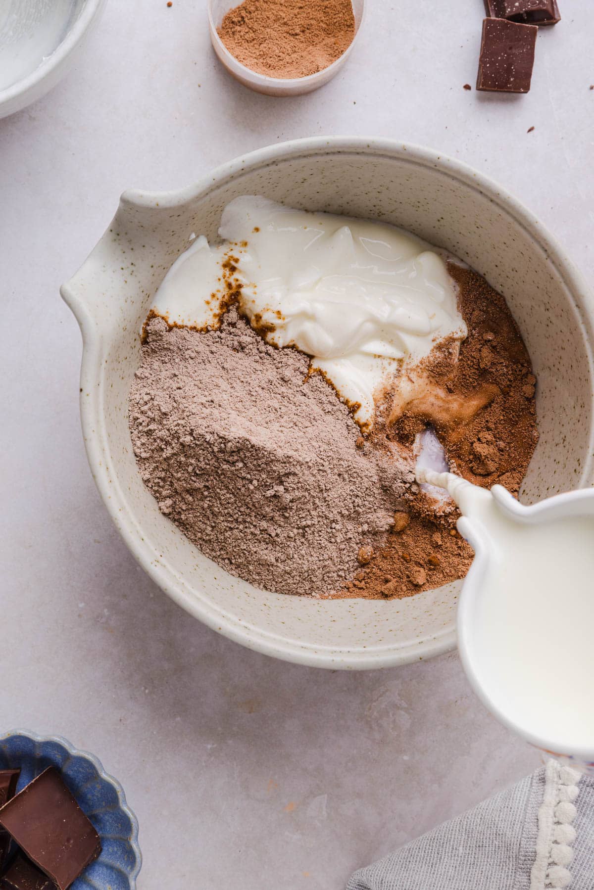 All of the ingredients for protein chocolate pudding in a large bowl before mixing.