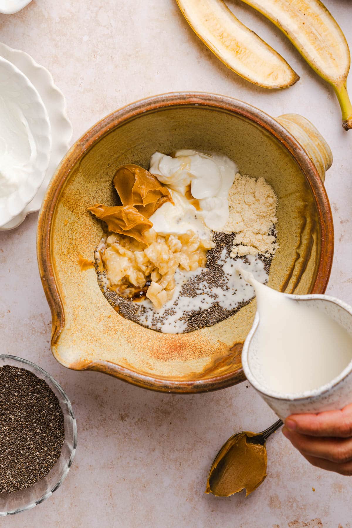 All of the ingredients for the chia pudding in a large bowl on a countertop.