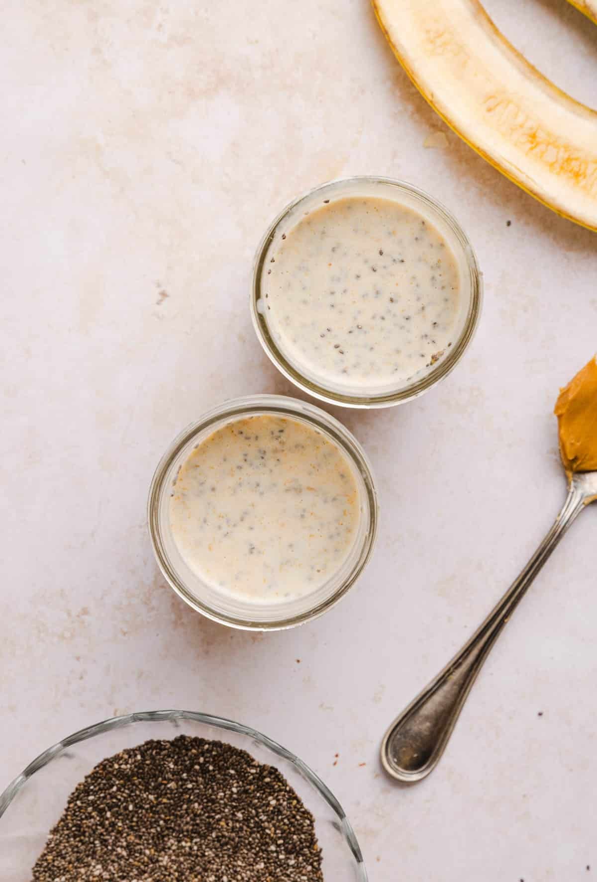The chia pudding mixture in two jars before chilling.