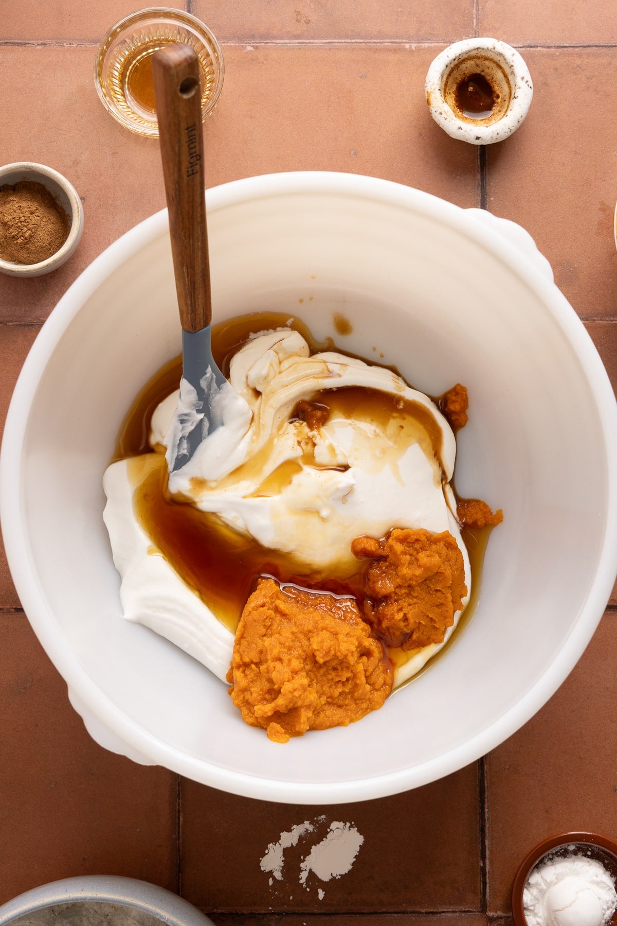 The blended cottage cheese, pumpkin puree, maple syrup, and vanilla in a bowl before mixing everything together.