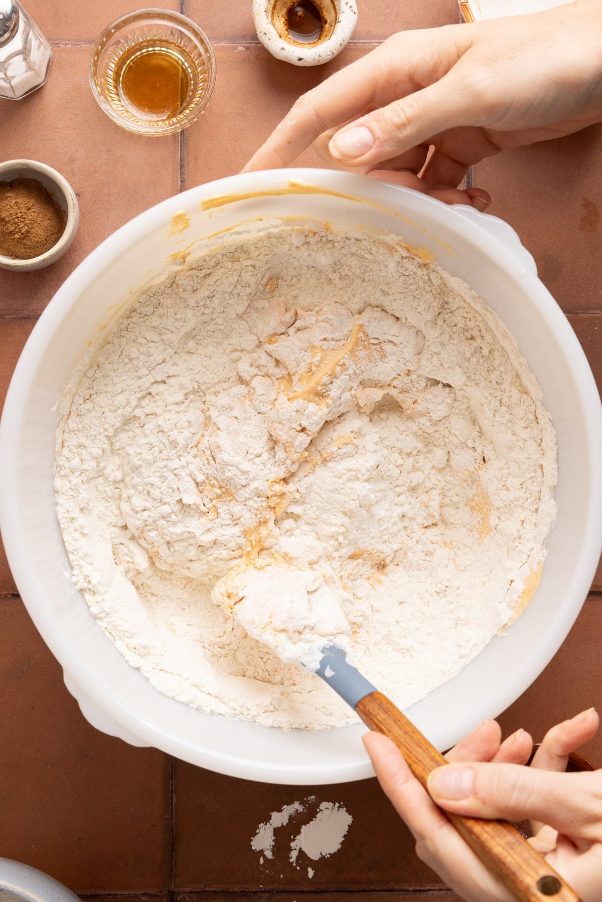 The flour, baking powder, pumpkin pie spice, and salt in the bowl with the blended pumpkin and cottage cheese mixture before stirring everything together.
