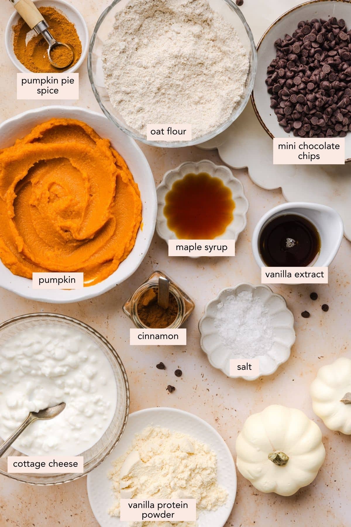 All of the ingredients for edible pumpkin cookie dough in bowls on a countertop.