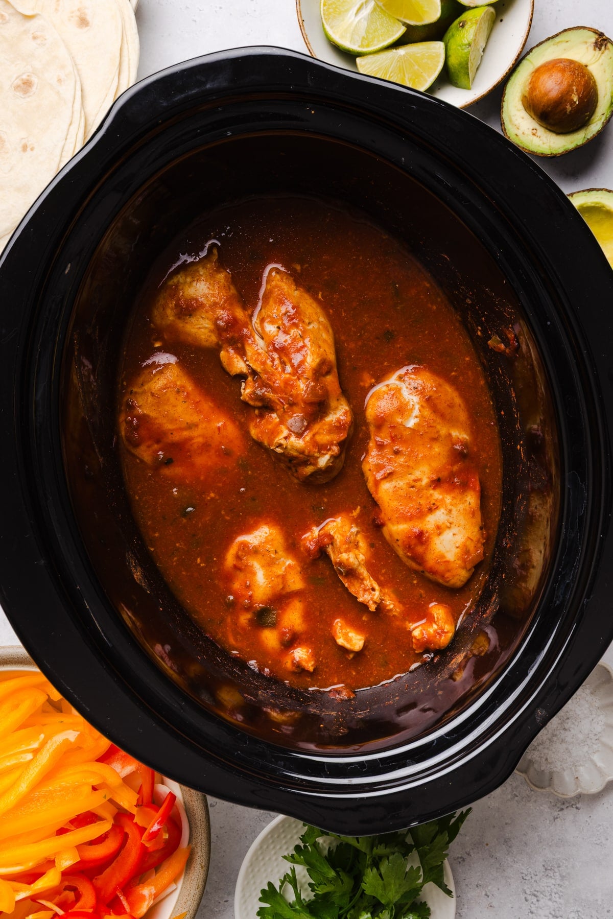 The chicken in the slow cooker after slow cooking.