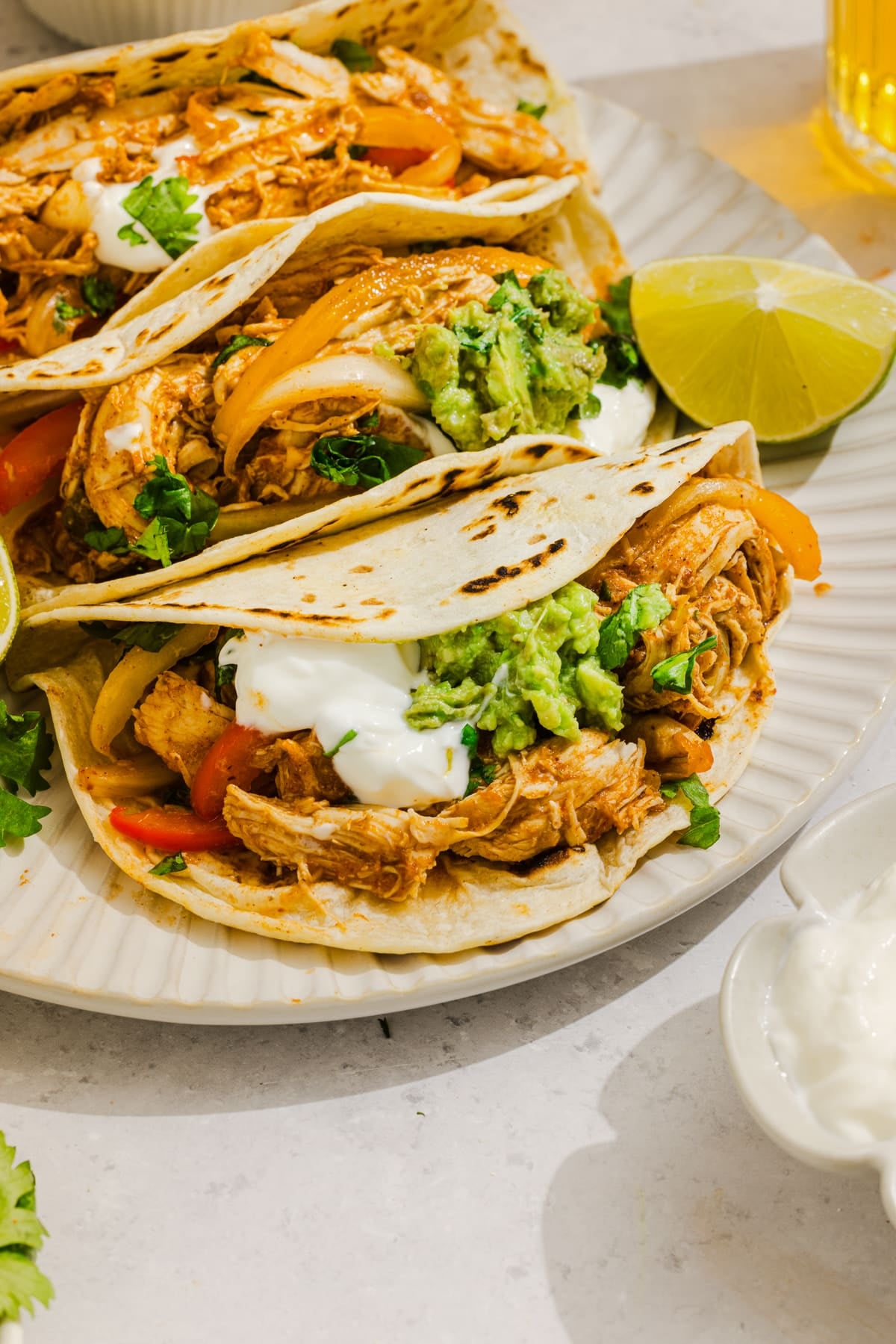 The chicken fajitas in warm tortillas with sour cream, guacamole and cilantro.