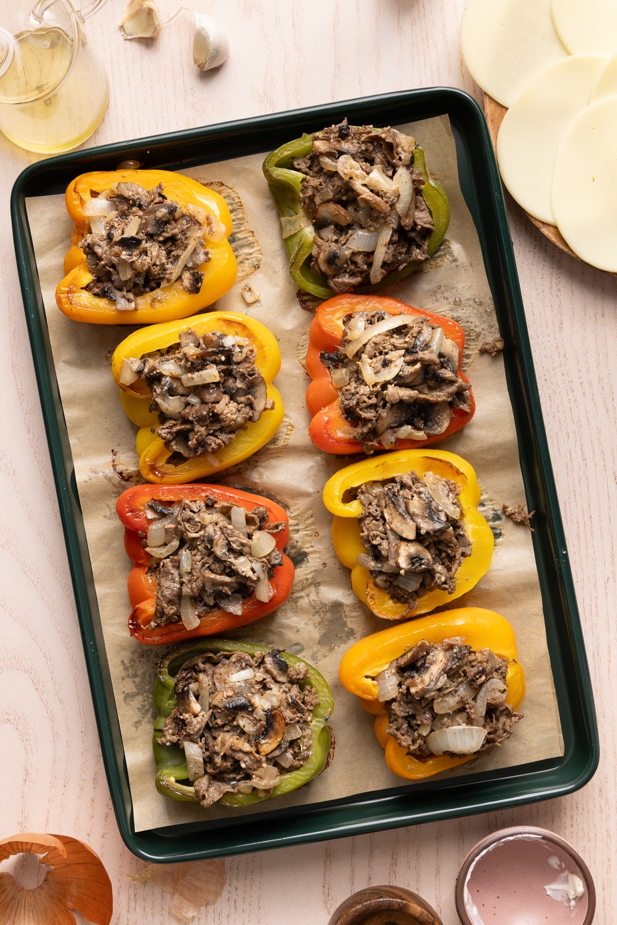 The peppers on a sheet pan stuffed with the creamy steak and onions mixture before adding the cheese.