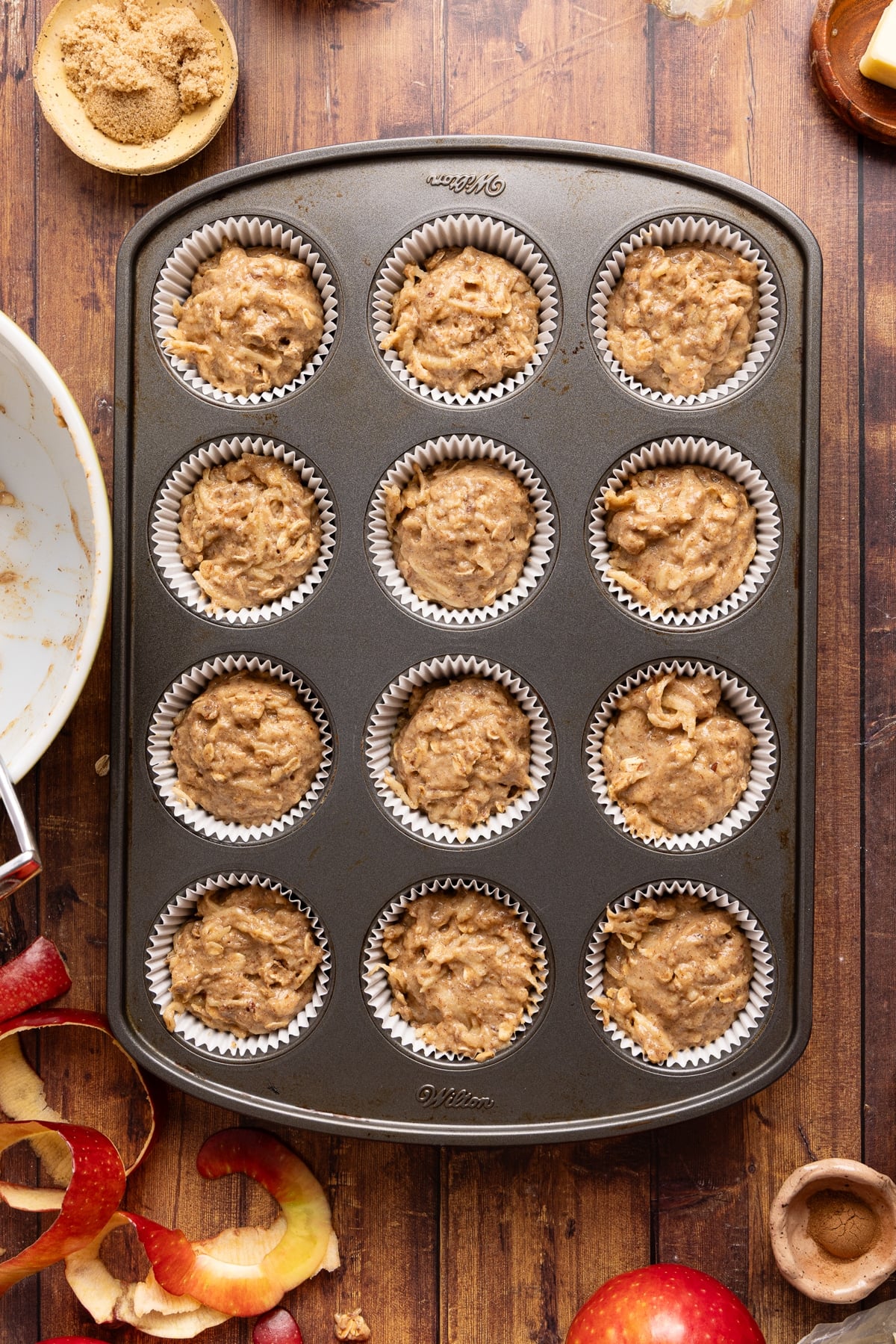 The batter divided into 12 lined muffin cups before adding the cinnamon streusel topping.