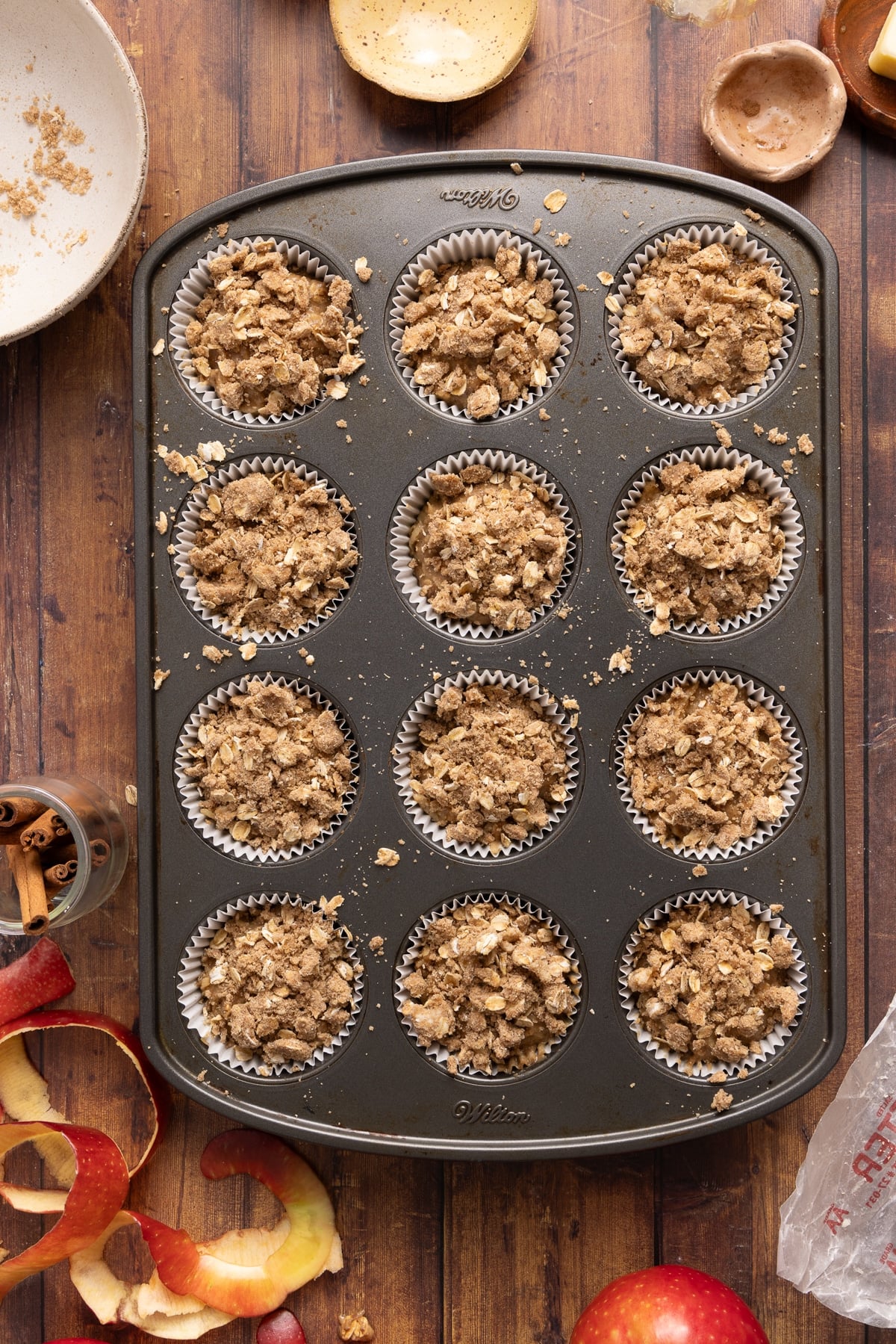 The muffin batter with the cinnamon streusel topping in the muffin pan before baking.