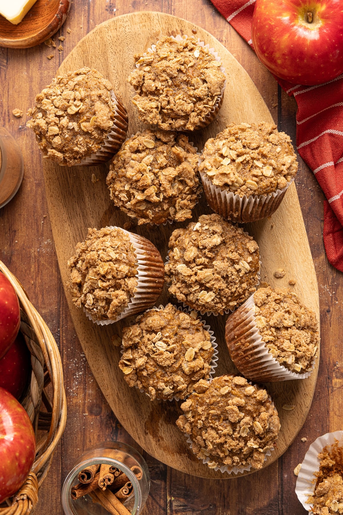 Apple cinnamon muffins on a wooden cutting board after baking.
