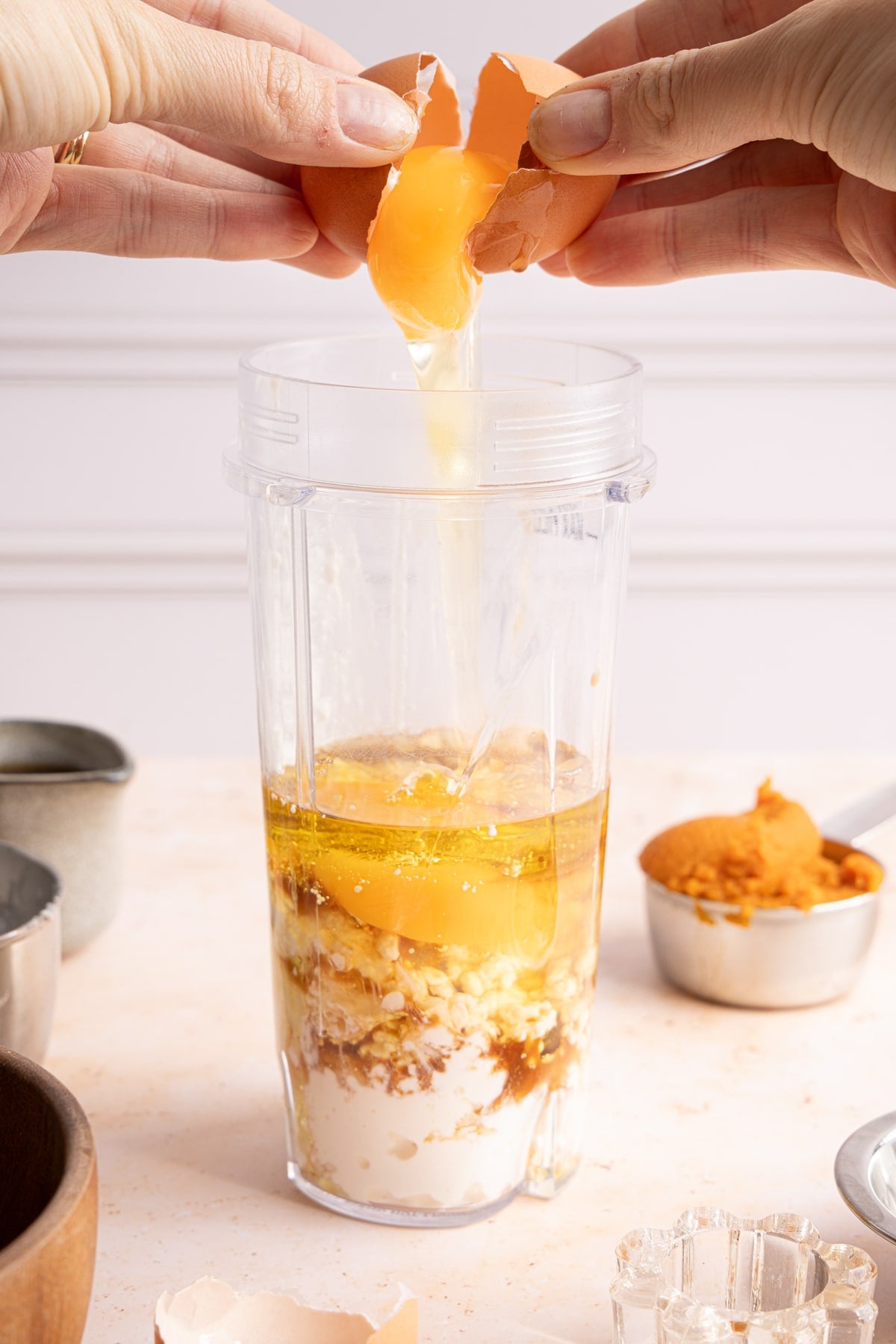 The cottage cheese, pumpkin puree, eggs, maple syrup, honey, avocado oil, and vanilla in a blender before mixing.