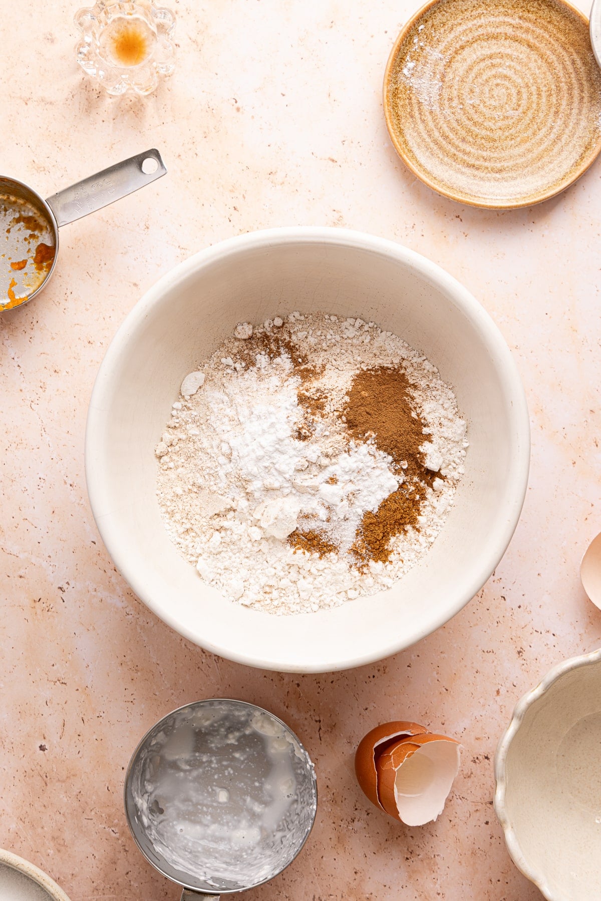 The dry ingredients in a large white bowl before mixing.