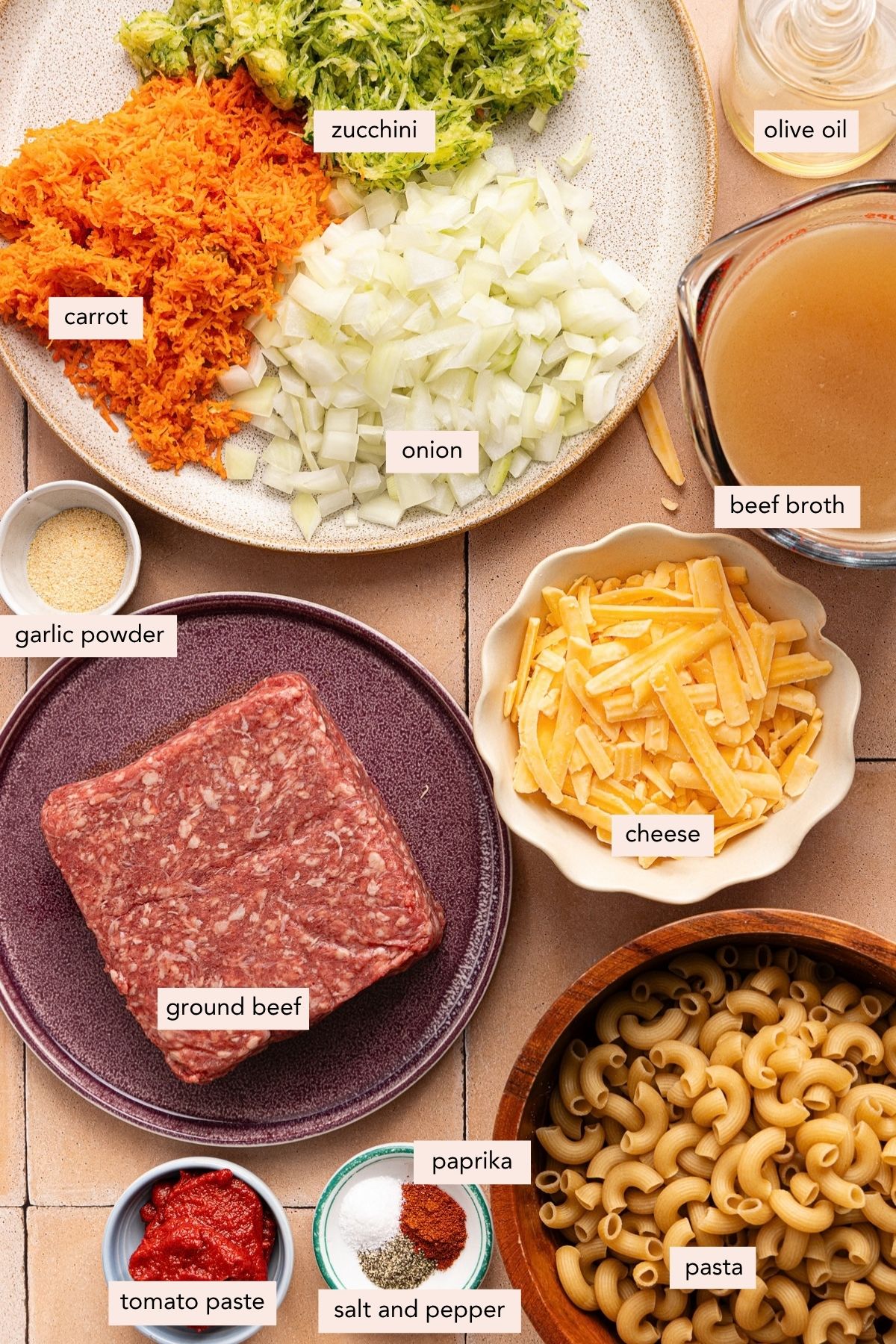 All of the ingredients for healthy hamburger helper in bowls on a countertop.