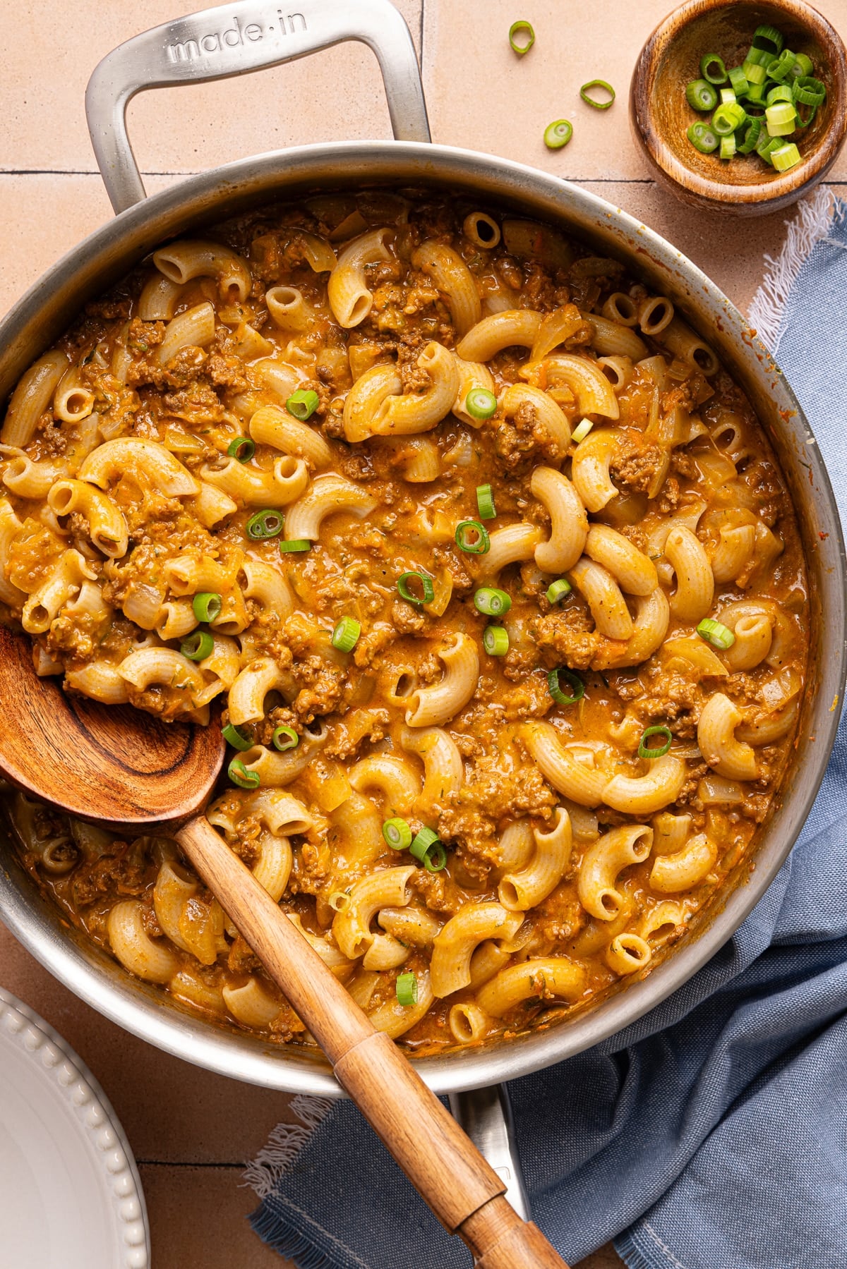 A wooden spoon rests in a pan of healthy hamburger helper.