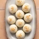 High protein pumpkin truffles sitting on a white serving platter.