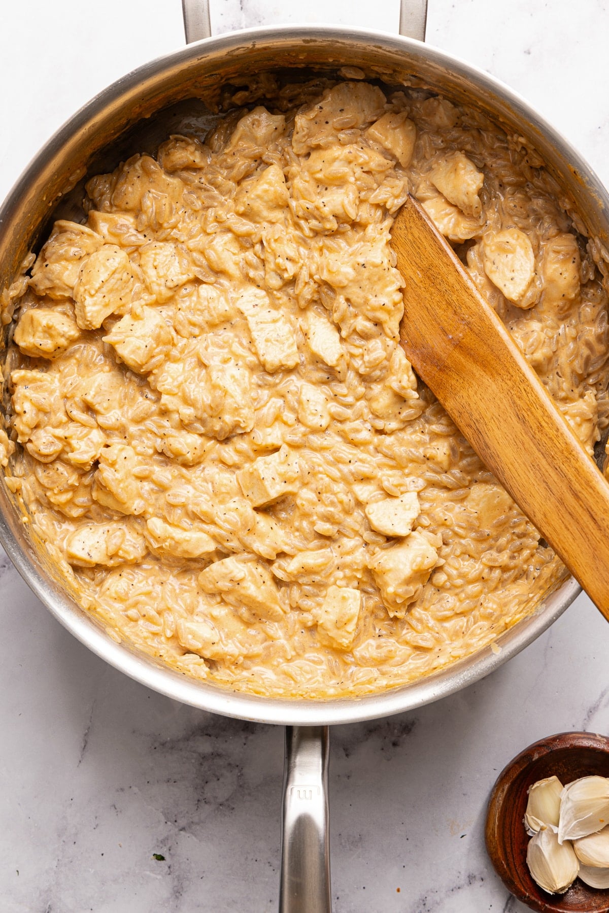 The marry me chicken orzo in the pan after simmering and before adding the parmesan cheese.