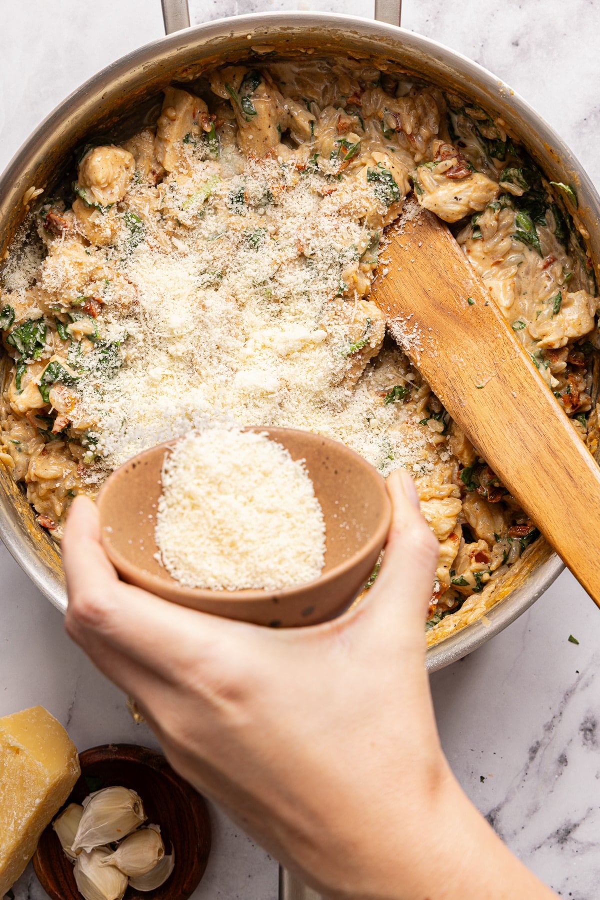 The Parmesan and lemon juice in the skillet before stirring.