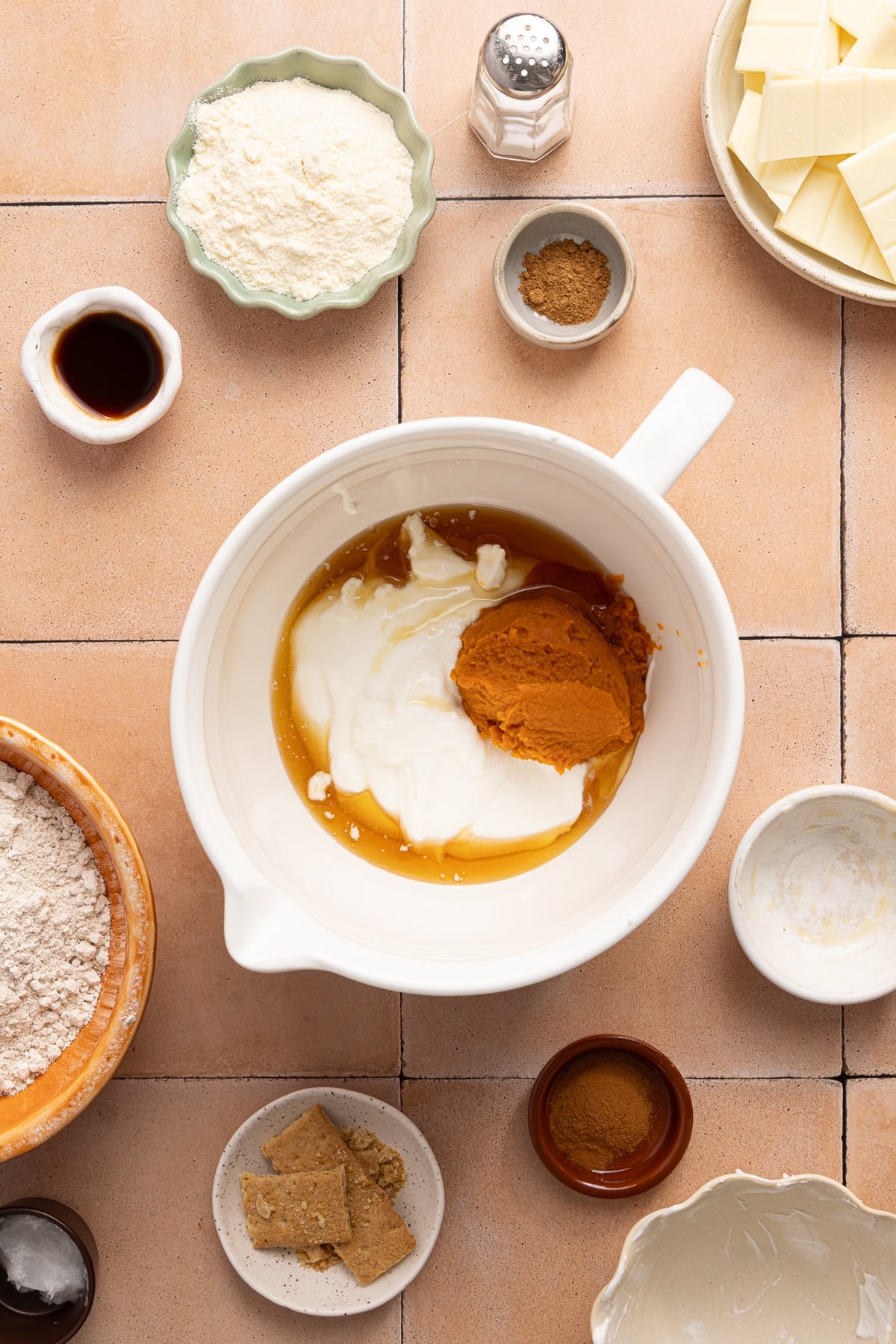 The blebded cottage cheese in a large bowl with the pumpkin puree, maple syrup, and vanilla.