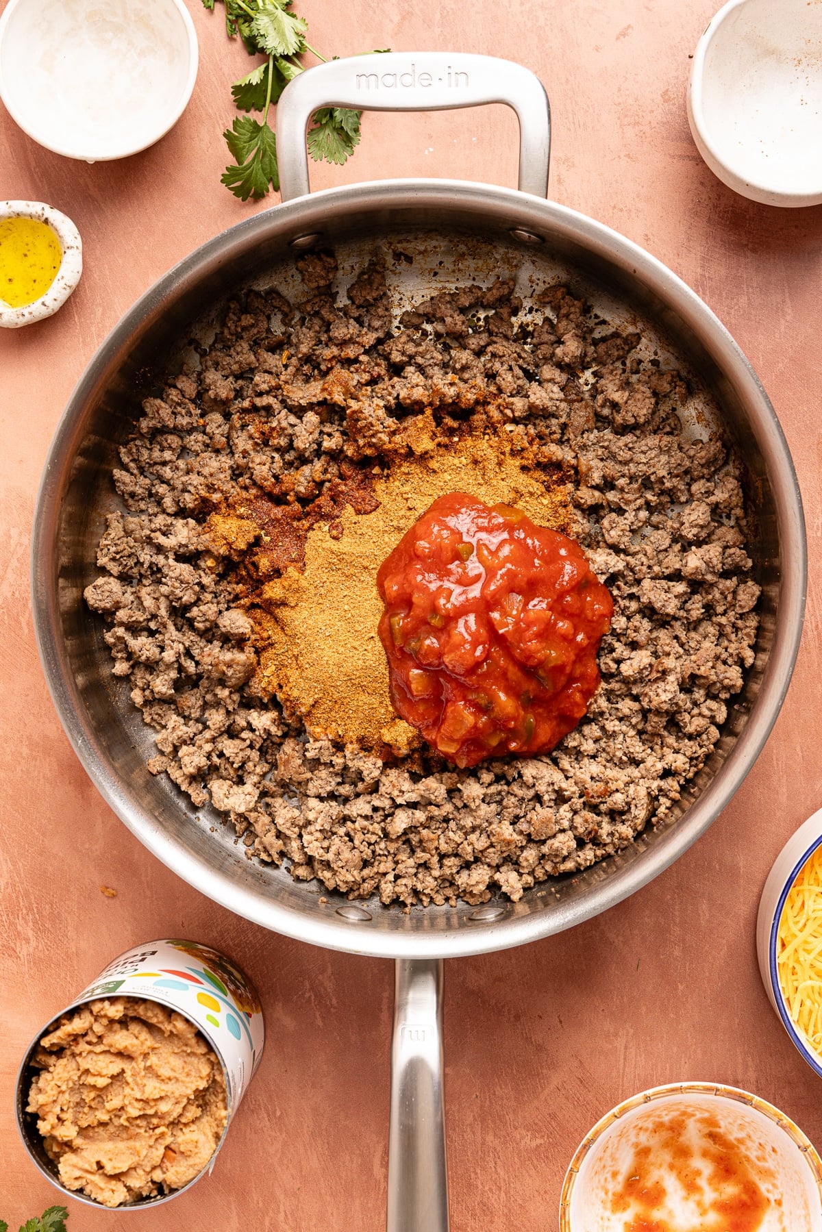 The cooked ground beef with the taco seasoning and salsa on top before stirring everything together.