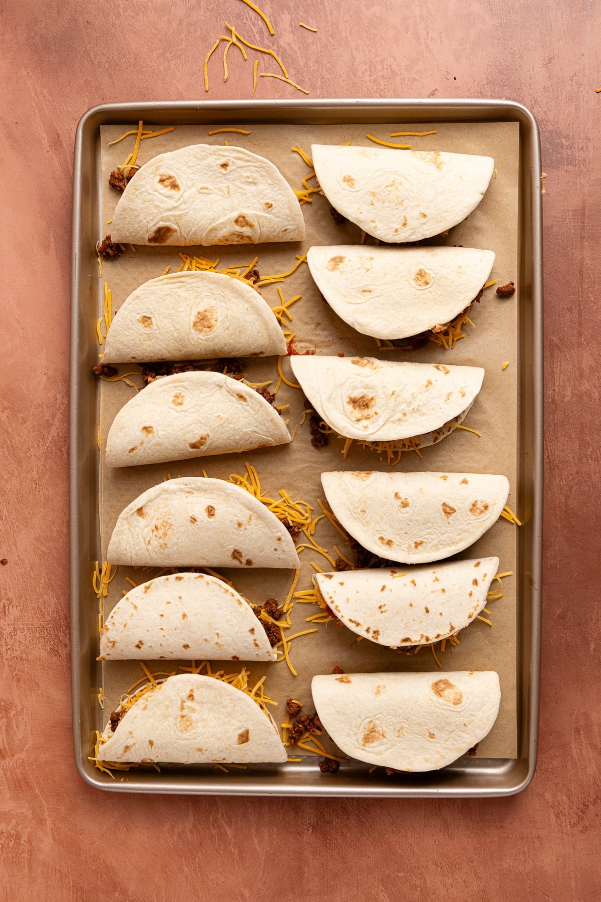 All 12 tacos on the sheet pan before going into the oven.