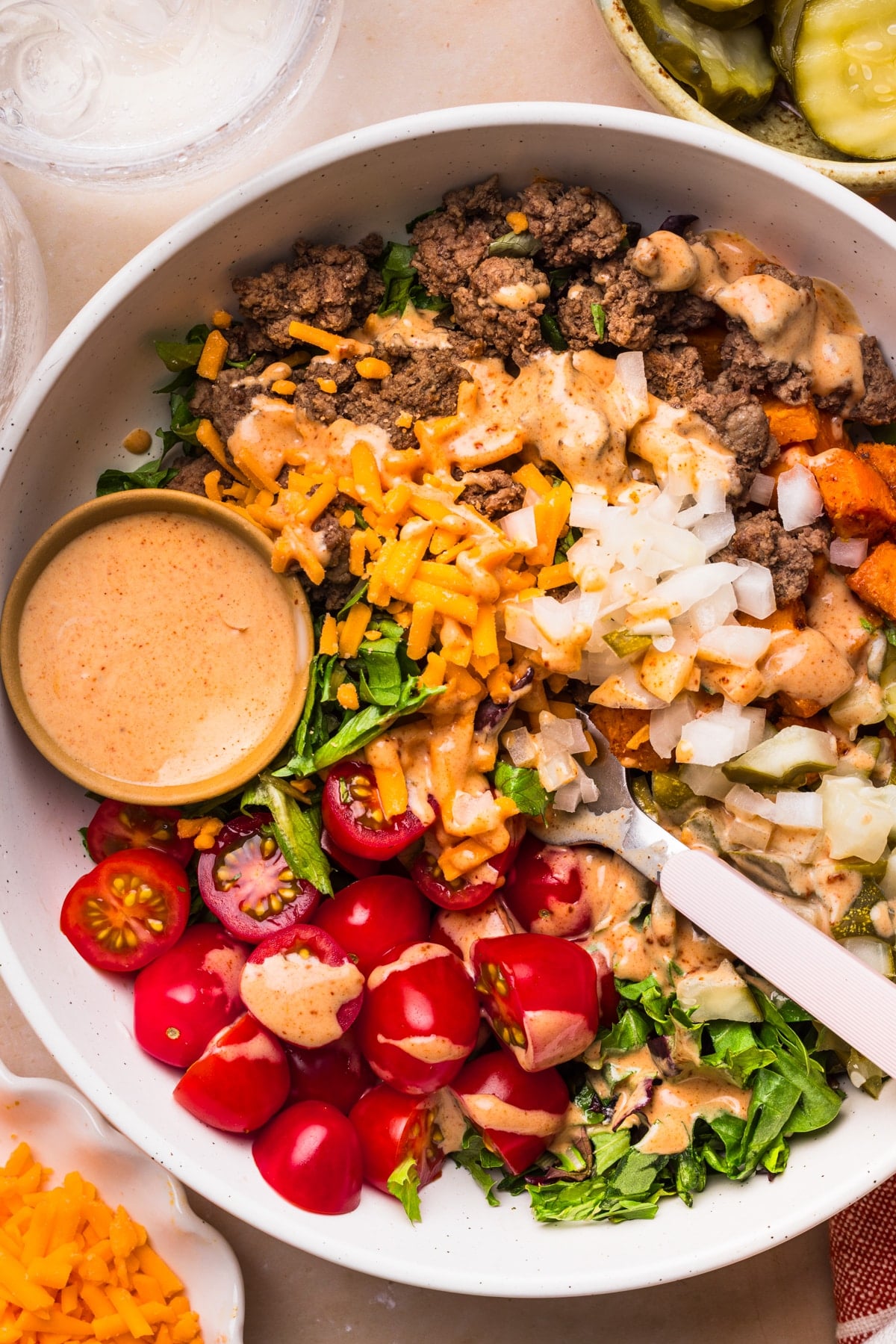 A fork in a sweet potato burger bowl ready for serving.