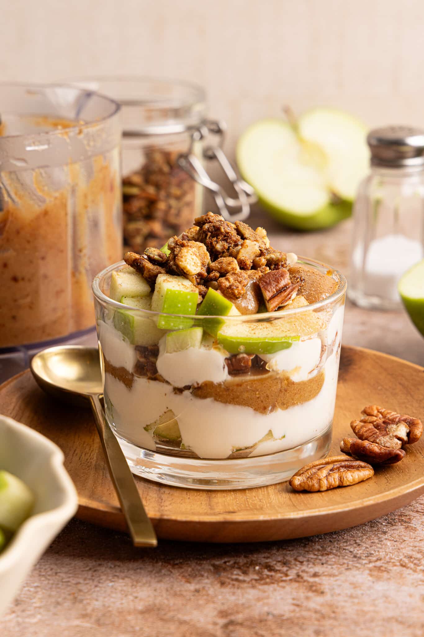 Green apple, date caramel and vanilla Greek yogurt layered in a glass jar.