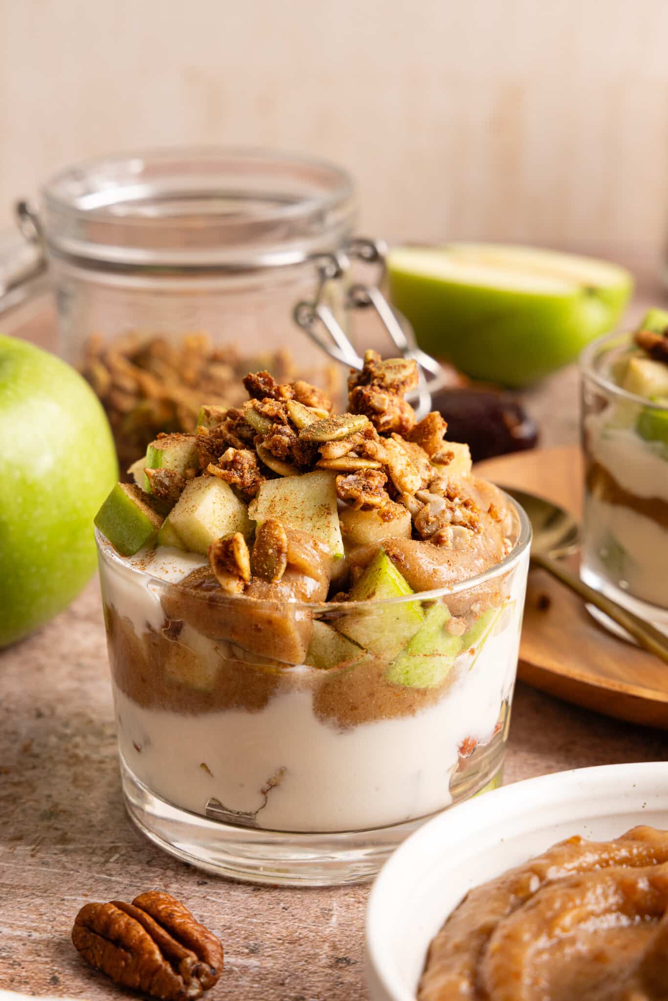 Green apple, date caramel and vanilla Greek yogurt layered in a glass jar.