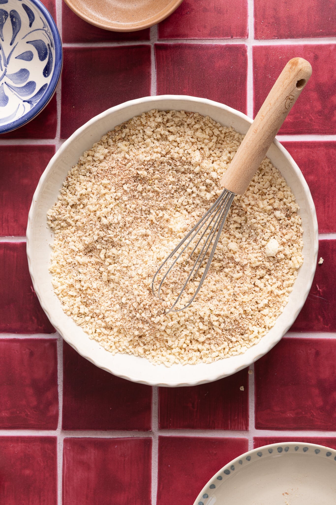The breadcrumbs in a large white bowl.