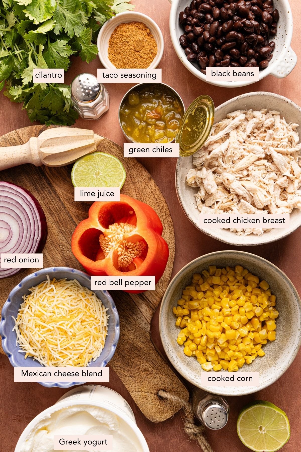 All of the ingredients for southwest chicken salad in bowls on a countertop.